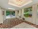 Bright sunroom featuring a unique tile floor, sliding glass doors to patio, and multiple windows at 3232 Johnny Cake Ln, Charlotte, NC 28226