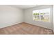 A sunlit bedroom with neutral walls and carpet and a large window at 3340 Burberry Dr, Gastonia, NC 28052
