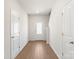 Bright entryway with wood-look floors, white trim, and a glass panel front door at 3340 Burberry Dr, Gastonia, NC 28052