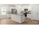 Bright kitchen featuring white cabinets, stainless steel appliances, and granite countertops at 3340 Burberry Dr, Gastonia, NC 28052