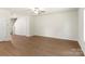 Spacious living room featuring wood-look floors, a ceiling fan, and neutral paint at 3340 Burberry Dr, Gastonia, NC 28052