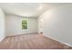Carpeted main bedroom with a window and an attached bathroom at 3340 Burberry Dr, Gastonia, NC 28052