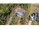 Aerial perspective featuring a beautiful home with a gray roof surrounded by lush greenery and mature trees at 4237 Island Fox Ln, Denver, NC 28037