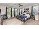 Inviting bedroom with large windows, neutral tones, and comfortable furnishings at 4237 Island Fox Ln, Denver, NC 28037