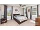 Cozy bedroom with large windows, neutral carpet, and ceiling fan at 4237 Island Fox Ln, Denver, NC 28037