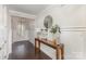 Bright entryway features dark wood floors, a console table, and an elegant mirror at 4237 Island Fox Ln, Denver, NC 28037