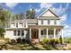 Charming two-story home with a large front porch and landscaped yard at 4237 Island Fox Ln, Denver, NC 28037