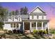 Charming two-story home with a large front porch and landscaped yard at 4237 Island Fox Ln, Denver, NC 28037