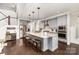 Bright kitchen featuring gray cabinets, granite countertops, stainless appliances, and seating around the island at 4237 Island Fox Ln, Denver, NC 28037