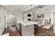 Open kitchen featuring granite countertops, stainless steel appliances, and a view of the living area at 4237 Island Fox Ln, Denver, NC 28037