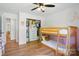 Cozy bedroom with bunk bed, built-in closet, and wood flooring at 4307 Wrangler Sw Dr, Concord, NC 28027