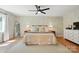 Spacious primary bedroom featuring hardwood floors, neutral decor, and a ceiling fan at 4307 Wrangler Sw Dr, Concord, NC 28027