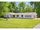 Inviting single-story home with a well-maintained lawn and an attached garage at 4307 Wrangler Sw Dr, Concord, NC 28027