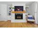 Fireplace and built-in shelving that highlights the living room, as well as the hardwood floors at 4307 Wrangler Sw Dr, Concord, NC 28027