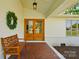 Cozy covered front porch featuring a wooden bench and double doors at 4307 Wrangler Sw Dr, Concord, NC 28027
