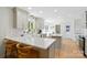 Bright kitchen with white countertops, a breakfast bar, and modern light fixtures at 4307 Wrangler Sw Dr, Concord, NC 28027