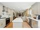 Spacious kitchen with stainless steel appliances and breakfast bar that opens into the living room area at 4307 Wrangler Sw Dr, Concord, NC 28027