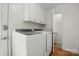 All-white laundry room with overhead cabinets and appliances that offer plenty of storage space at 4307 Wrangler Sw Dr, Concord, NC 28027