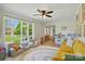Bright living room features a ceiling fan, hardwood floors, large window with a view of the front yard at 4307 Wrangler Sw Dr, Concord, NC 28027