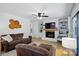 Inviting living room featuring hardwood floors, a cozy couch, and a fireplace with built-in shelving at 4307 Wrangler Sw Dr, Concord, NC 28027