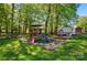 Backyard with play area including playhouse, playset with slide and swing set, and a large grassy area at 4307 Wrangler Sw Dr, Concord, NC 28027