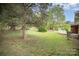 Backyard featuring mature trees, lawn, air conditioning unit and concrete patio at 4921 Churchill Dr, Charlotte, NC 28269