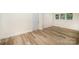 Bright bedroom features wood-look flooring, a window with natural light and a white door at 4921 Churchill Dr, Charlotte, NC 28269