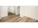 Bright bedroom features wood-look flooring, a closet and a white door to hall at 4921 Churchill Dr, Charlotte, NC 28269