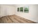 Bright bedroom features wood-look flooring, large windows with natural light, and a closet at 4921 Churchill Dr, Charlotte, NC 28269