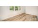 Cozy bedroom featuring hardwood floors and plenty of natural light at 4921 Churchill Dr, Charlotte, NC 28269