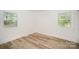 Bright bedroom features wood-look flooring and large windows with view to the backyard at 4921 Churchill Dr, Charlotte, NC 28269
