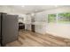 Stylish kitchen features white cabinets, stainless appliances, and bright natural light at 4921 Churchill Dr, Charlotte, NC 28269