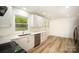 Bright kitchen features white cabinets, stainless appliances, and view to the yard at 4921 Churchill Dr, Charlotte, NC 28269