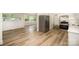 Open concept kitchen with stainless refrigerator and view to dining area and large windows at 4921 Churchill Dr, Charlotte, NC 28269
