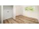 Bright laundry room includes wood-look flooring, hookups, and door to the backyard at 4921 Churchill Dr, Charlotte, NC 28269