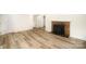 Spacious living area with new flooring and a cozy brick fireplace at 4921 Churchill Dr, Charlotte, NC 28269