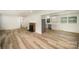 Open-concept living room and kitchen area with new flooring and stainless steel appliances at 4921 Churchill Dr, Charlotte, NC 28269