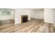 Bright, open living room featuring new flooring and a charming fireplace at 4921 Churchill Dr, Charlotte, NC 28269