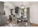 Cozy eat-in kitchen, featuring wood floors, modern light fixture, gray cabinetry, and breakfast area at 505 Tea Olive Ct, Rock Hill, SC 29732