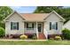 Charming single-story home featuring green shutters, a covered porch, and well-manicured landscaping at 505 Tea Olive Ct, Rock Hill, SC 29732