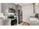 Well-equipped kitchen featuring stainless steel appliances, granite countertops, and wood-style floors at 505 Tea Olive Ct, Rock Hill, SC 29732
