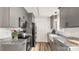 Modern kitchen features gray cabinetry, stainless steel appliances, and granite countertops with a farmhouse sink at 505 Tea Olive Ct, Rock Hill, SC 29732