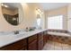 Bright bathroom featuring double vanity, large mirrors, and a separate tub and shower at 520 Steeple Chase Trl, Salisbury, NC 28144