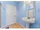 Bright bathroom with a pedestal sink and neutral tiling at 520 Steeple Chase Trl, Salisbury, NC 28144
