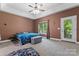 A spacious main bedroom with carpet flooring, natural lighting, and neutral walls at 520 Steeple Chase Trl, Salisbury, NC 28144