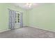 Bright bedroom with carpet, ceiling fan, and a window dressed with patterned curtains, perfect for relaxation at 520 Steeple Chase Trl, Salisbury, NC 28144