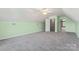 Inviting carpeted bonus room with an open doorway, ceiling fan, and ample natural light for versatile use at 520 Steeple Chase Trl, Salisbury, NC 28144