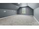 Large bonus room featuring carpeted flooring, a window, and a neutral color palette, ready for customization at 520 Steeple Chase Trl, Salisbury, NC 28144