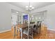 Elegant dining room with hardwood floors, a wooden table, and a view into the living area at 520 Steeple Chase Trl, Salisbury, NC 28144
