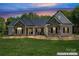 Charming exterior of home featuring stone accents, a metal roof, and a manicured lawn at 520 Steeple Chase Trl, Salisbury, NC 28144